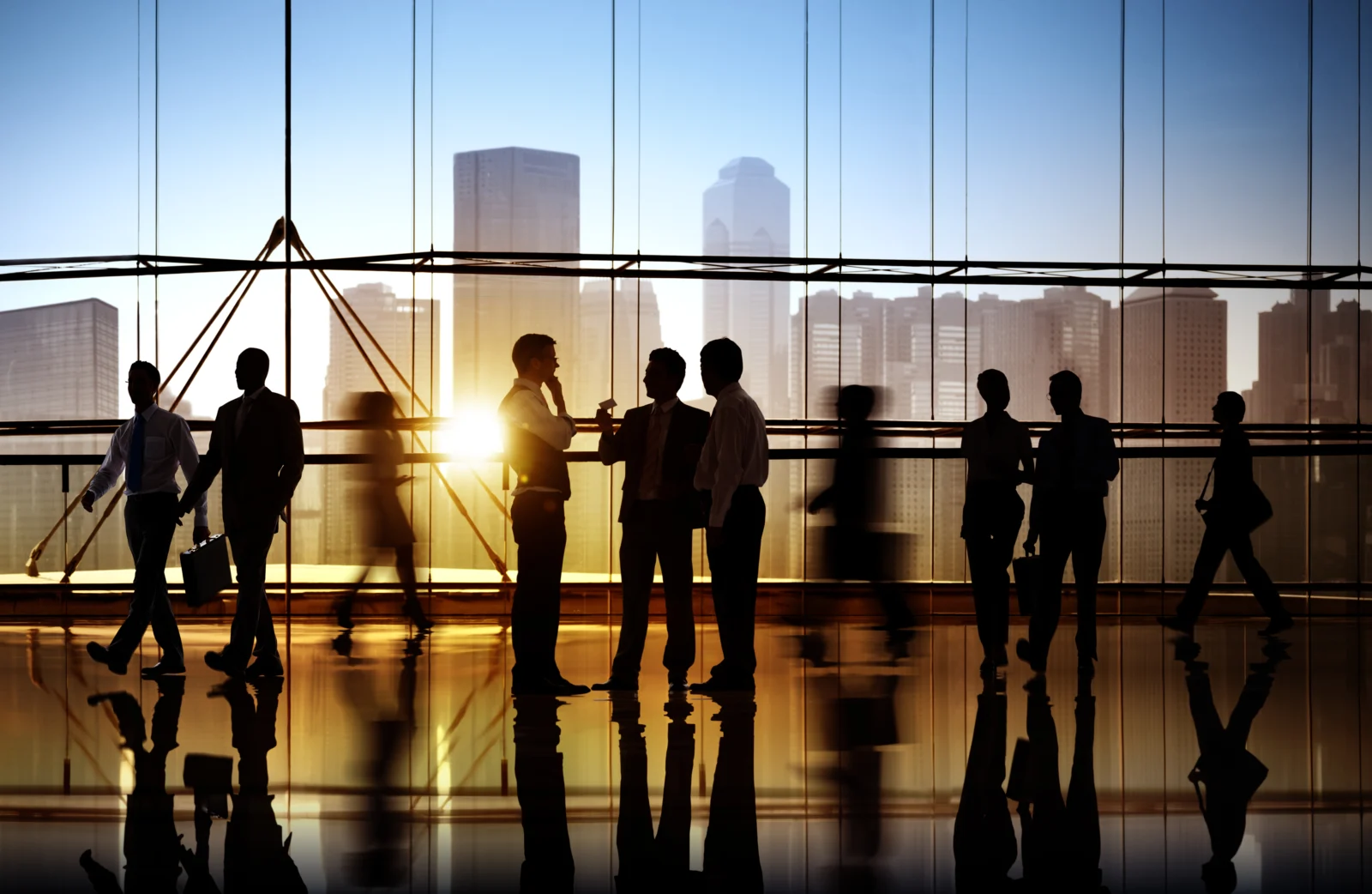 Business people meeting in an office lobby at sunset