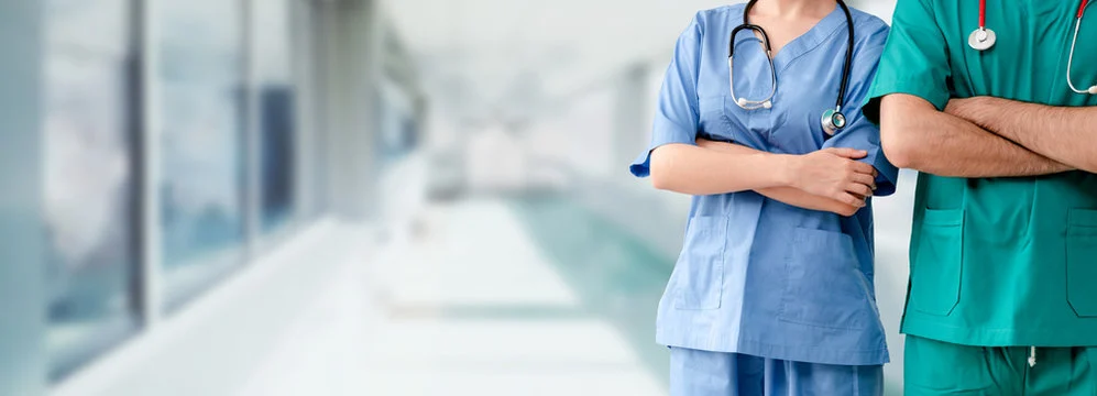 Two clinical staff in a hospital corridor