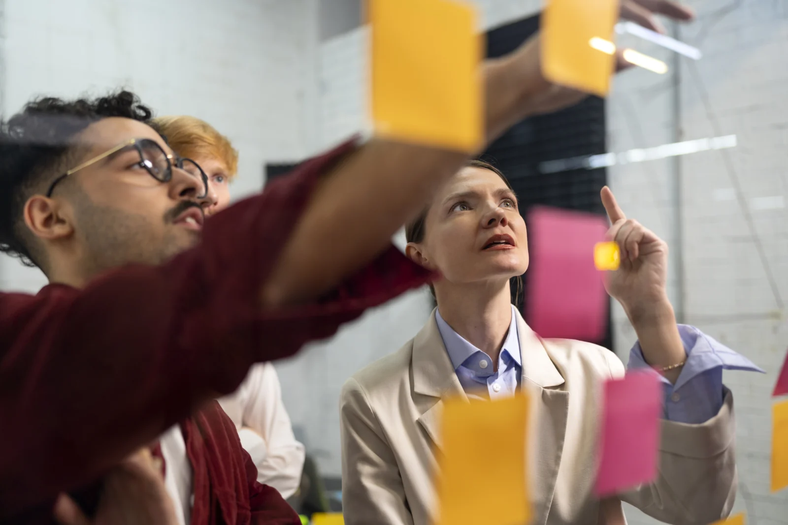 Consultants mapping a plan on a glass wall