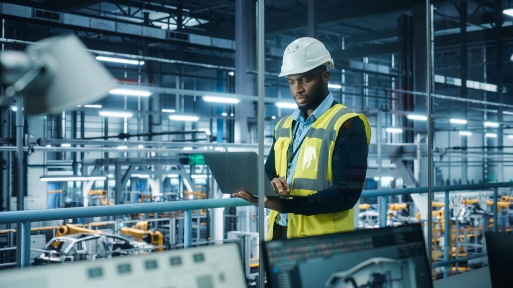 Engineer checking production data on a laptop