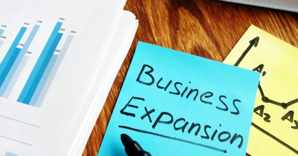 Expansion planning notes and charts on a desk